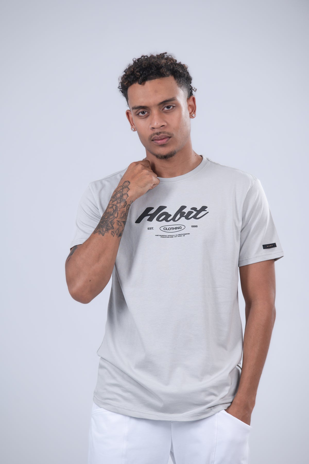 A light gray t-shirt with a black 'Habit' graphic on the chest.